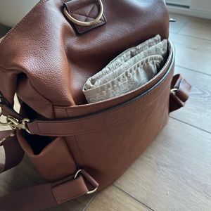 Twelve littles Peek a boo hobo vegan leather diaper bag. Color is toffee